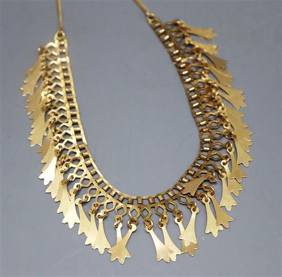 A yellow metal fringe necklace of openwork design hung with tulip-shaped drops (tests as 18ct), approx 25g.